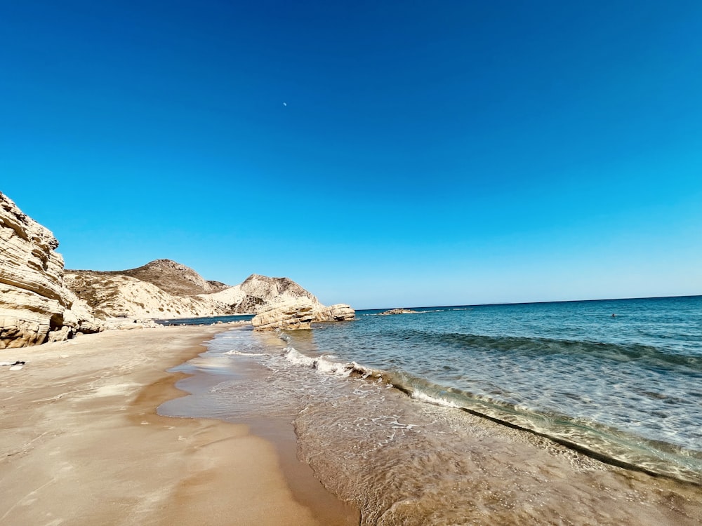 praia de areia marrom durante o dia
