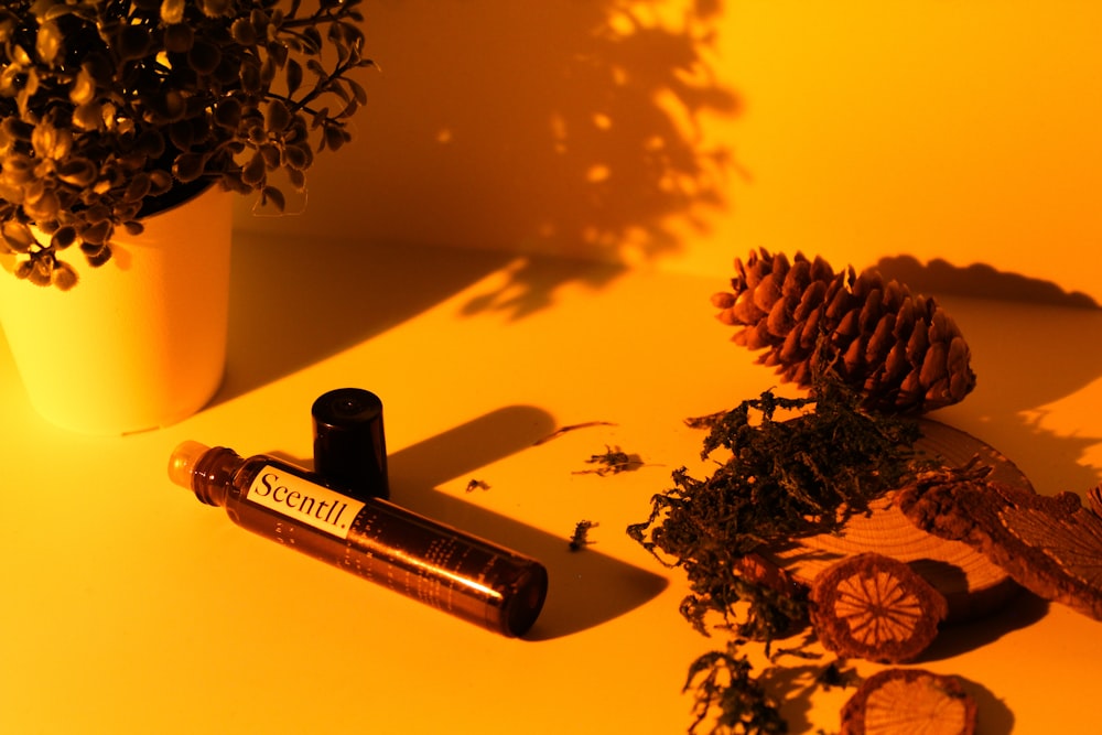 black and silver tube bottle on white table