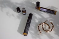 An inviting flat lay of premium fragrances and lifestyle accessories on a marble surface.