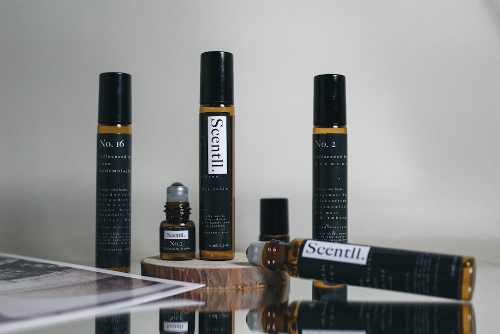 black and brown plastic bottles on brown wooden shelf