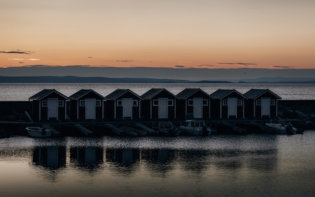 white and gray house on water during sunset
