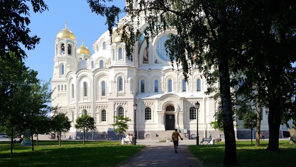 people walking near white concrete building during daytime