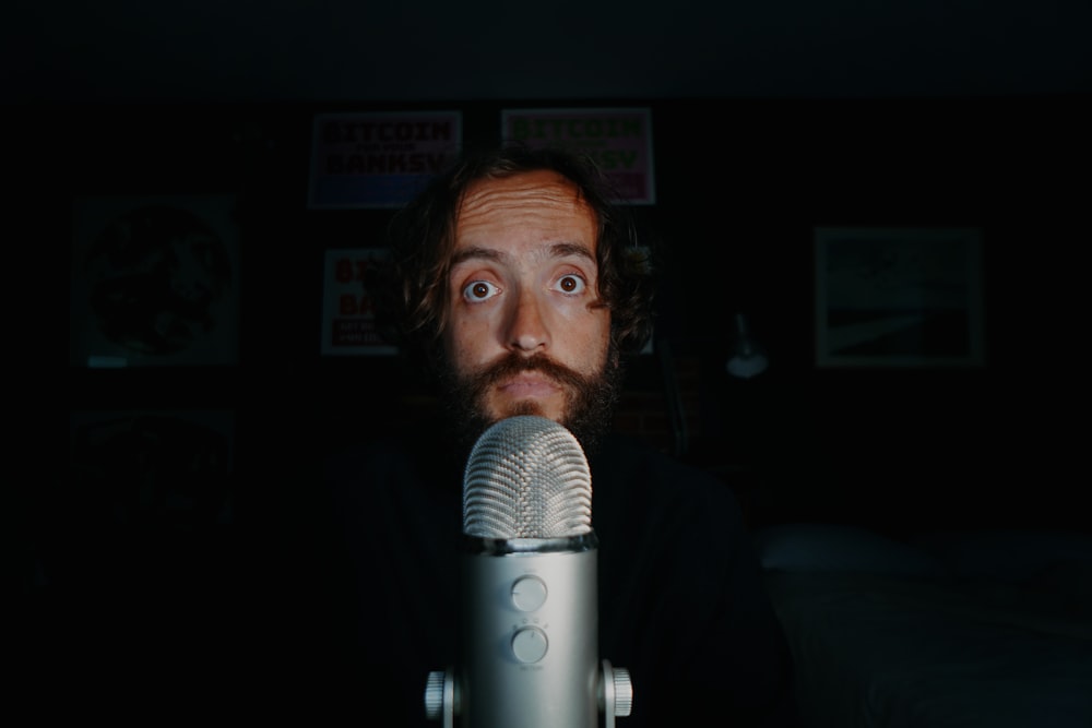 man singing in front of microphone