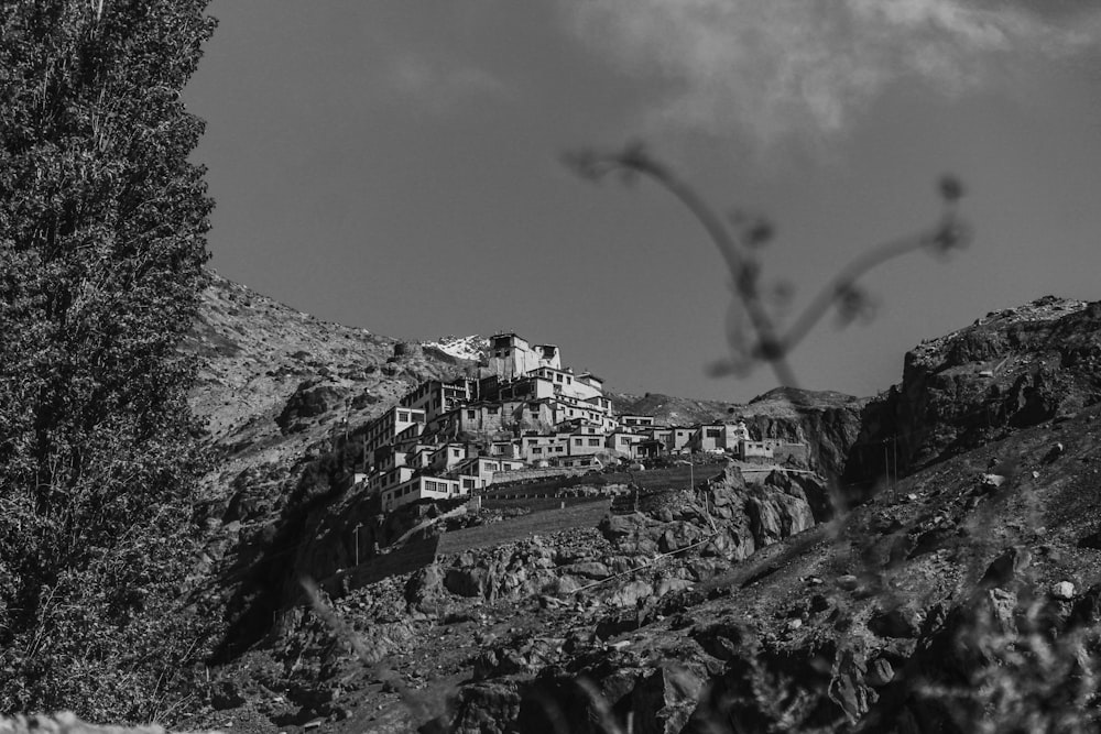 grayscale photo of city buildings under cloudy sky