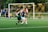 women playing soccer on green field during daytime