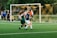 women playing soccer on green field during daytime