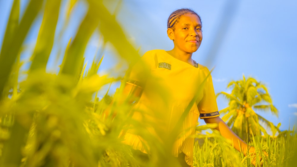 man in yellow polo shirt standing on green grass field during daytime