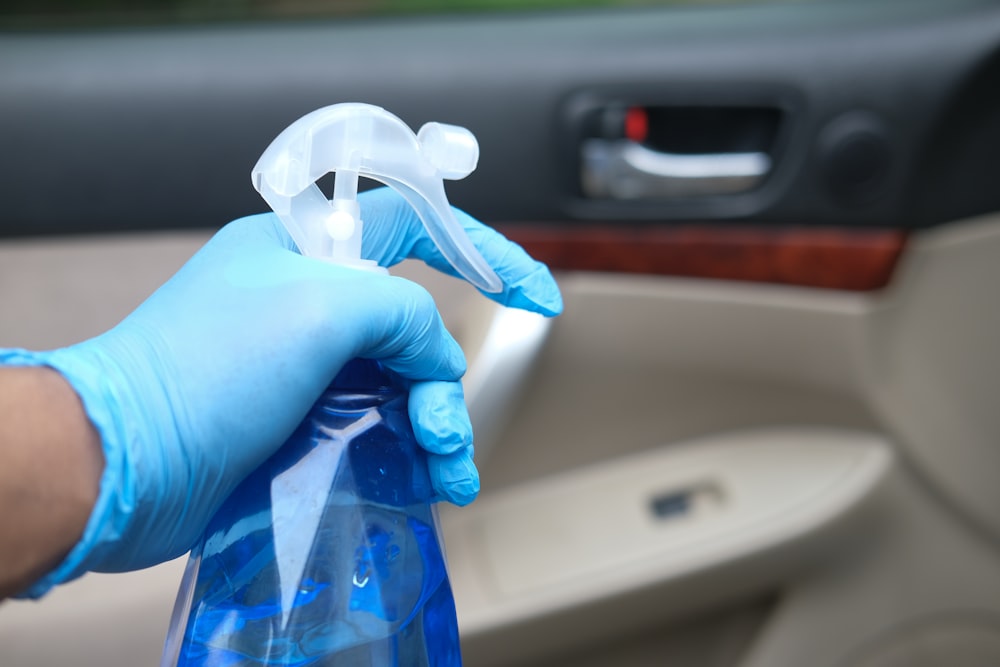 person holding blue and white plastic bag