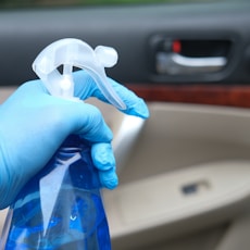 person holding blue and white plastic bag