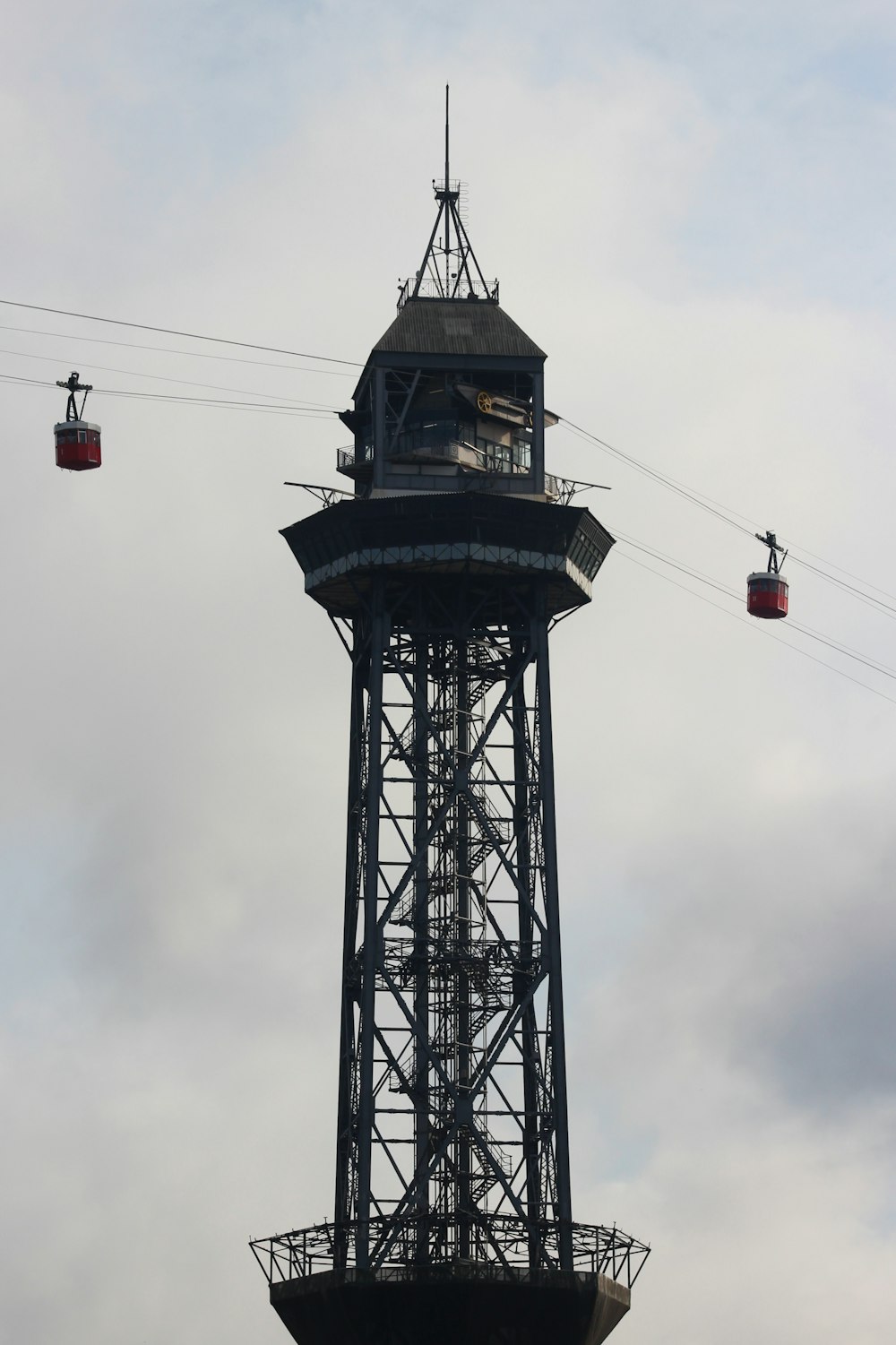 black and red tower under cloudy sky