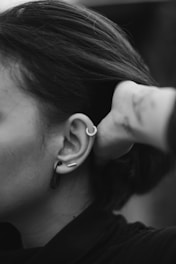woman with silver heart earring