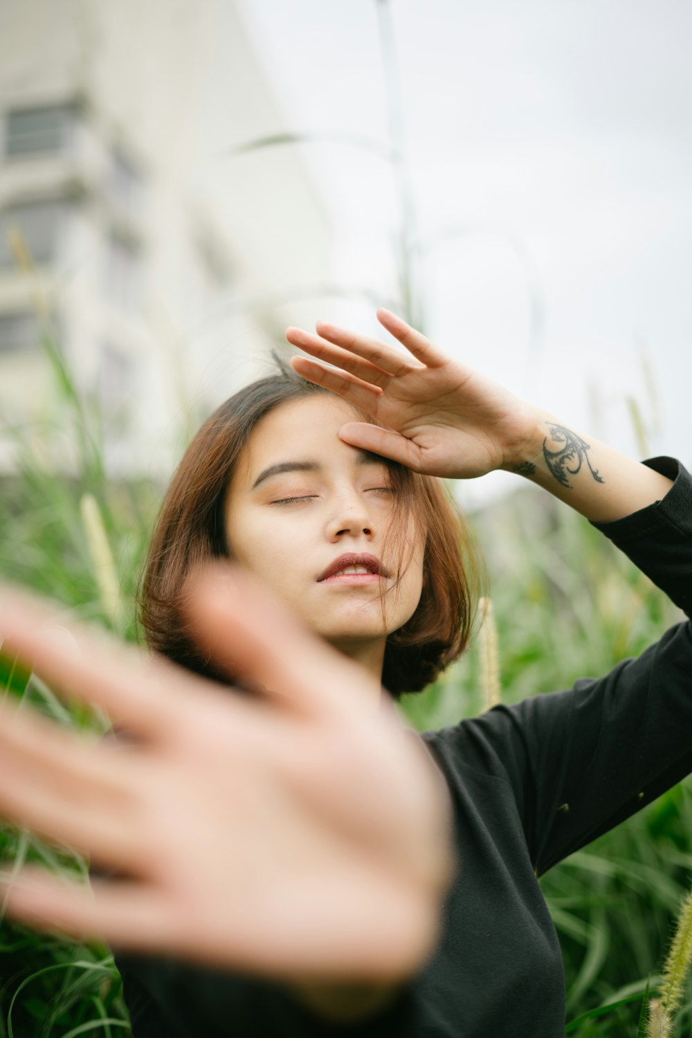 woman in black long sleeve shirt raising her right hand