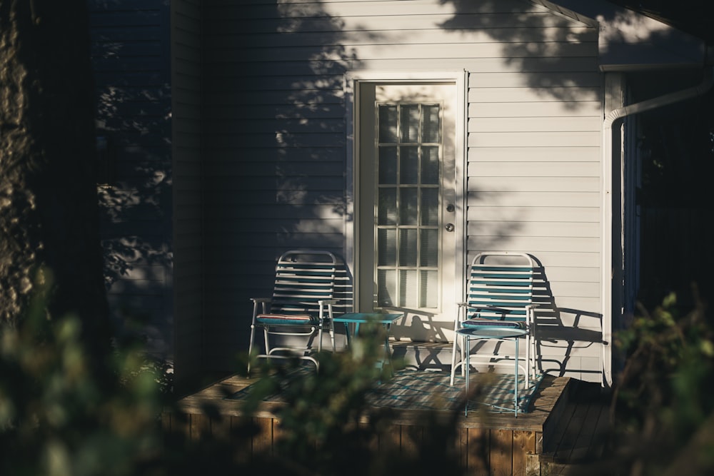 black and white wooden armchair beside white wooden house