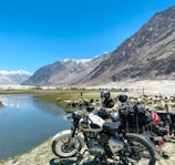 black motorcycle parked near lake during daytime