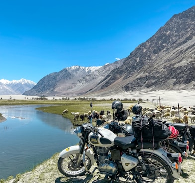 black motorcycle parked near lake during daytime