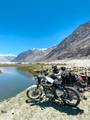 black motorcycle parked near lake during daytime