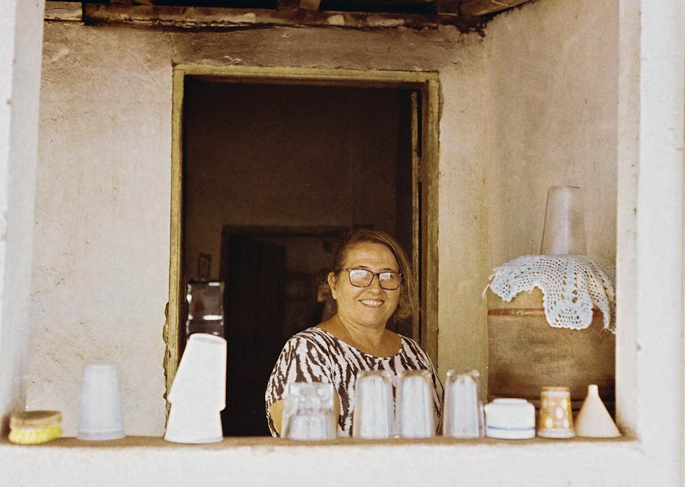 woman in white and black stripe shirt wearing eyeglasses