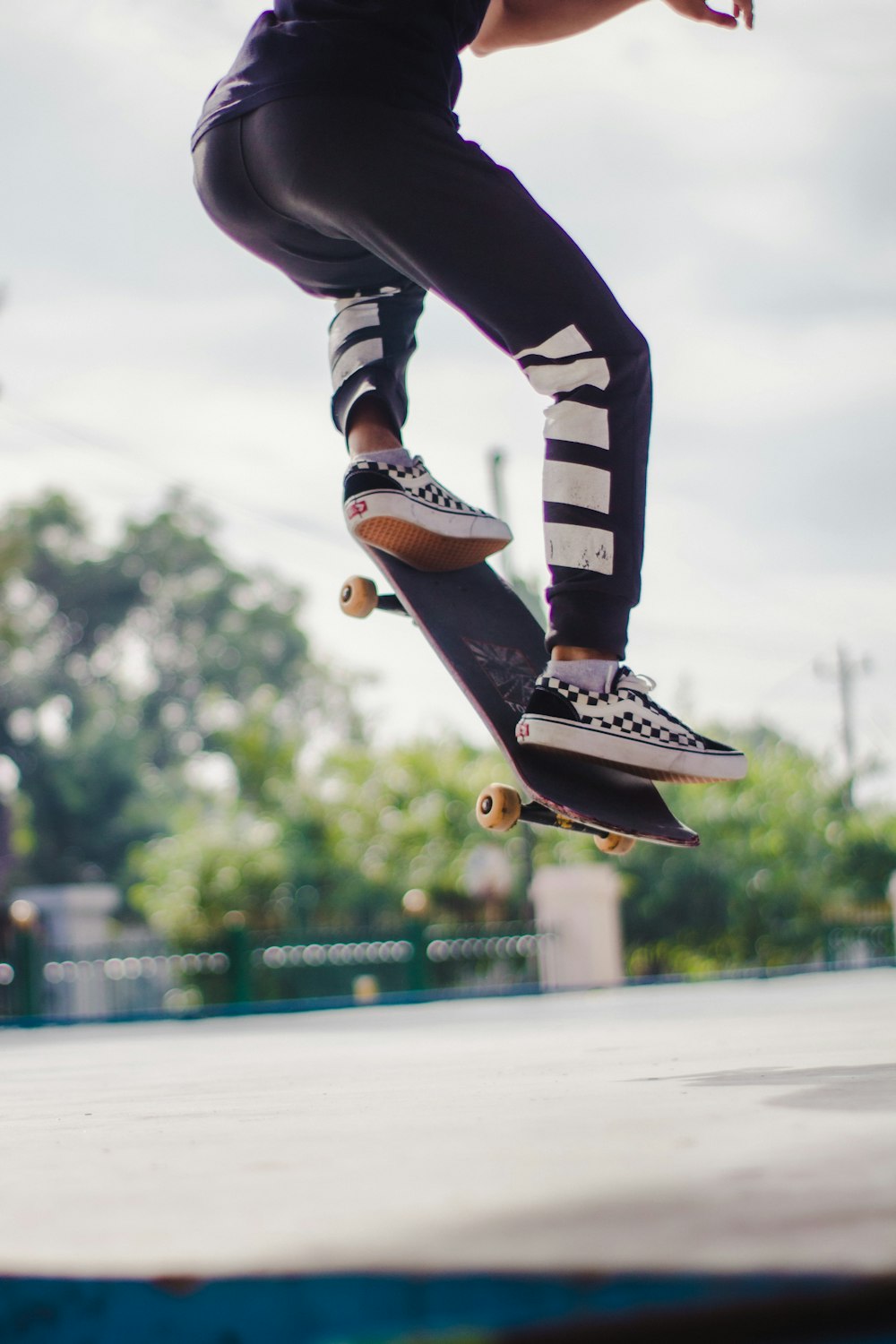 Person in black pants and black and white nike sneakers jumping on  skateboard during daytime photo – Free Skateboard Image on Unsplash