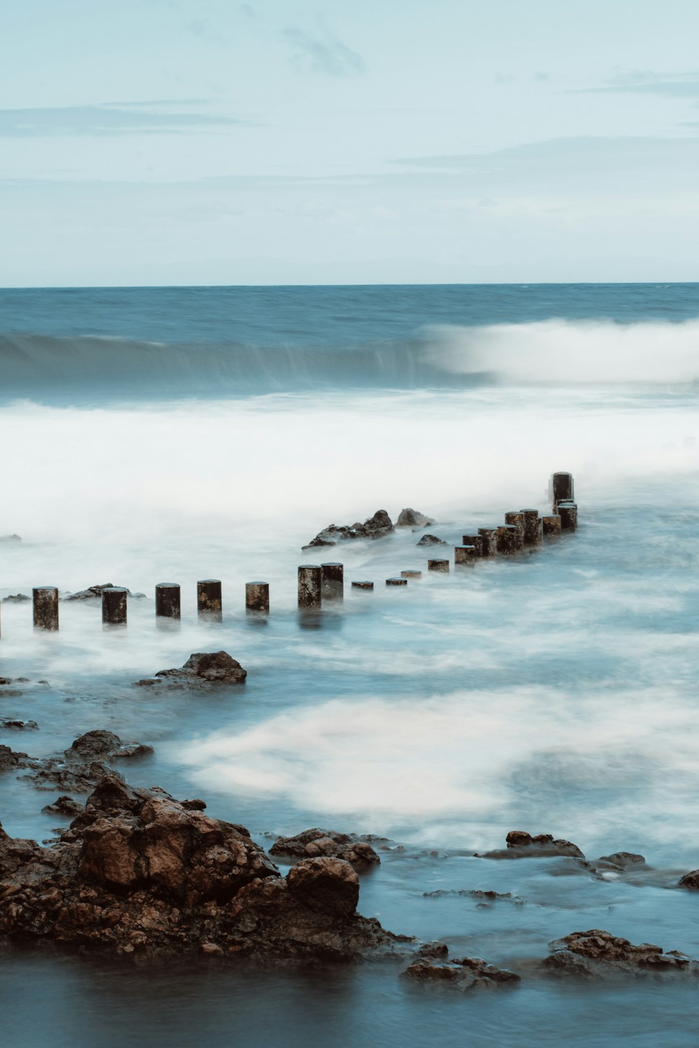 white and gray concrete blocks on body of water