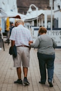 man in white and black striped polo shirt standing beside woman in black and white striped