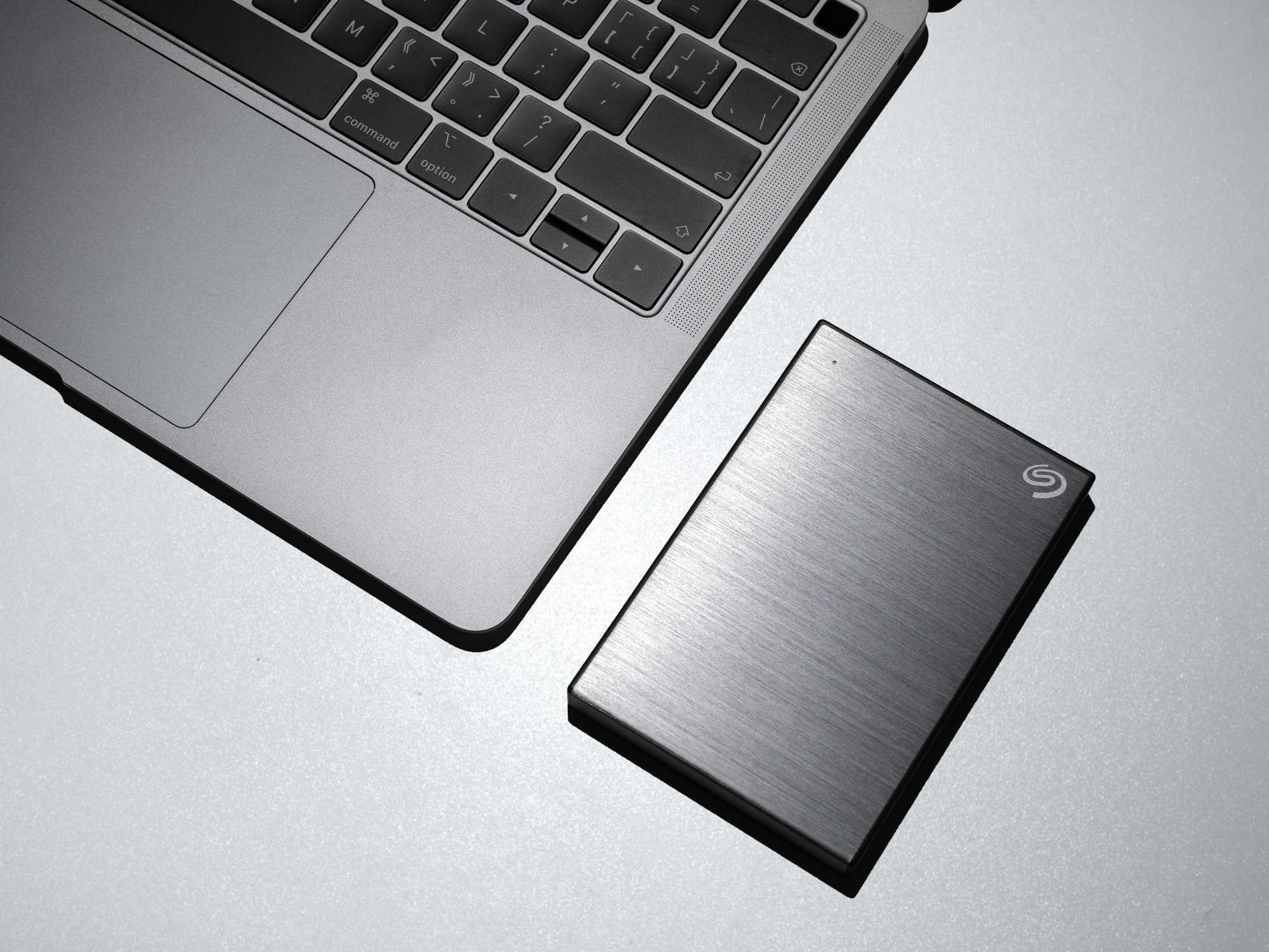 An external hard drive with a brushed stainless steel case.