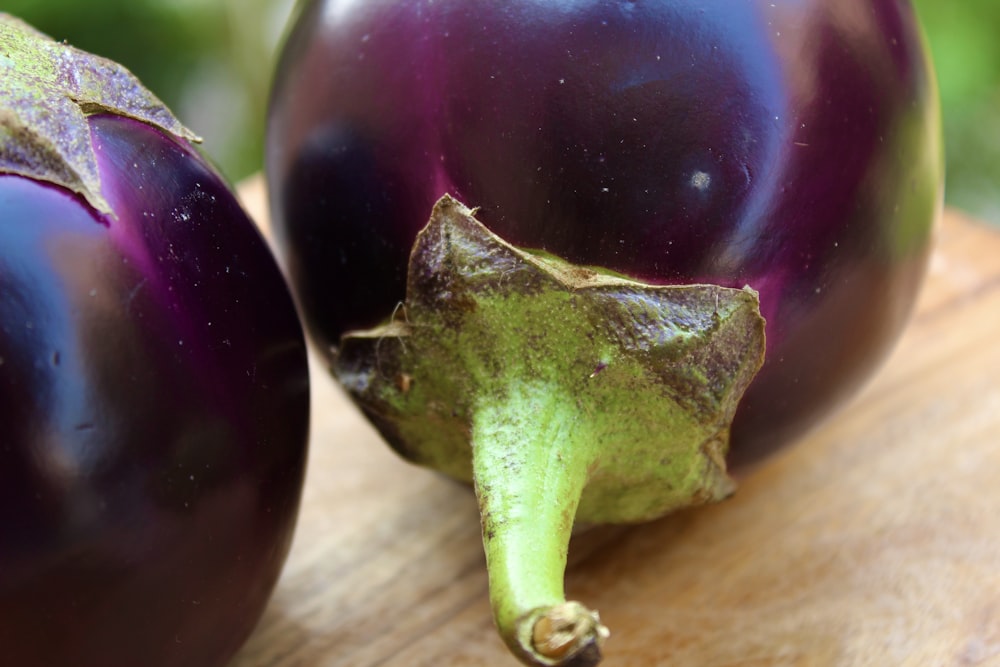 purple round fruit on brown wooden table