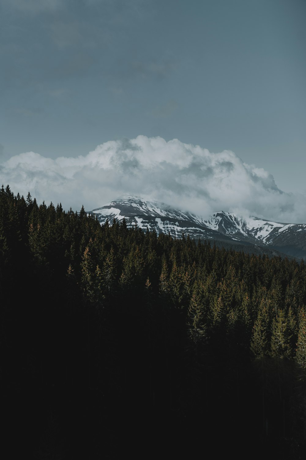 snow covered mountain under cloudy sky during daytime