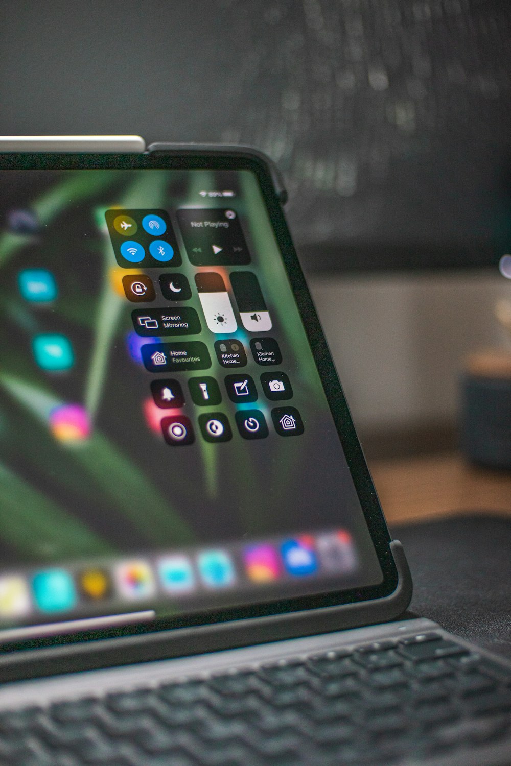 black ipad on brown wooden table