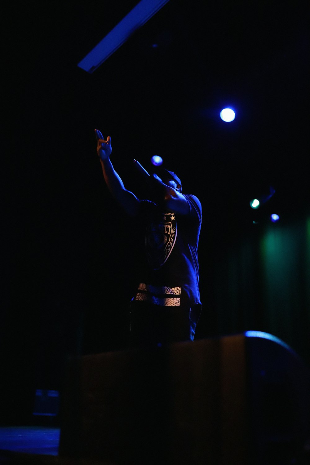 man in black long sleeve shirt standing on stage