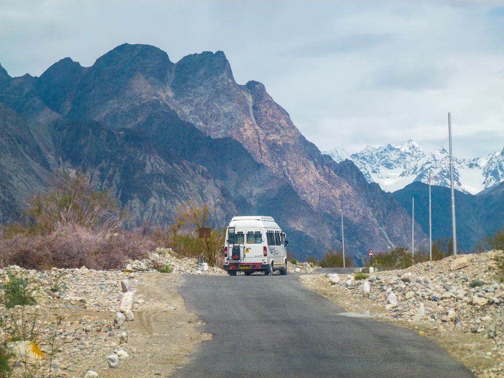 white van on road near mountain during daytime