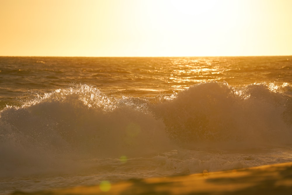 ocean waves crashing on shore during daytime