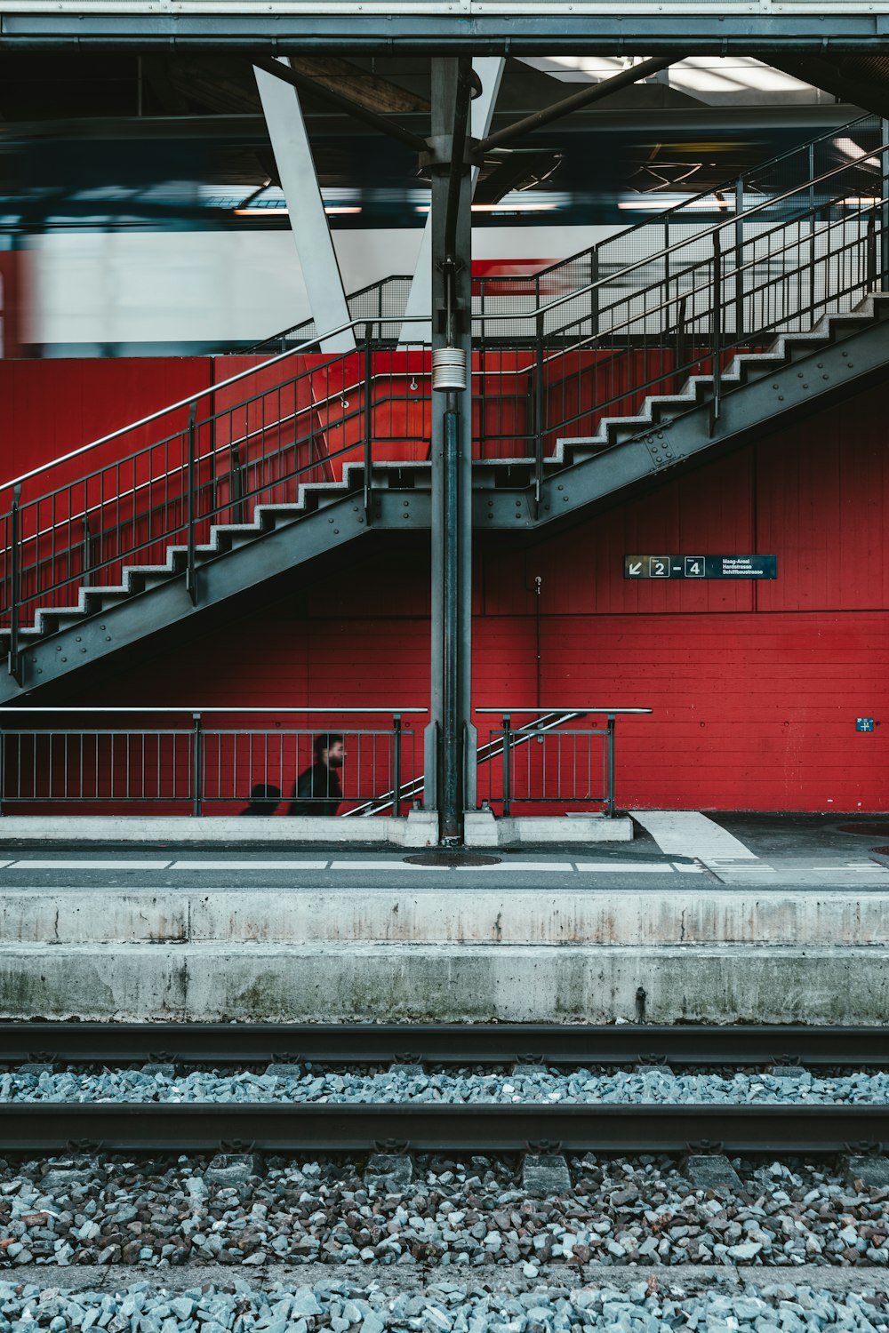 red metal railings on gray concrete floor