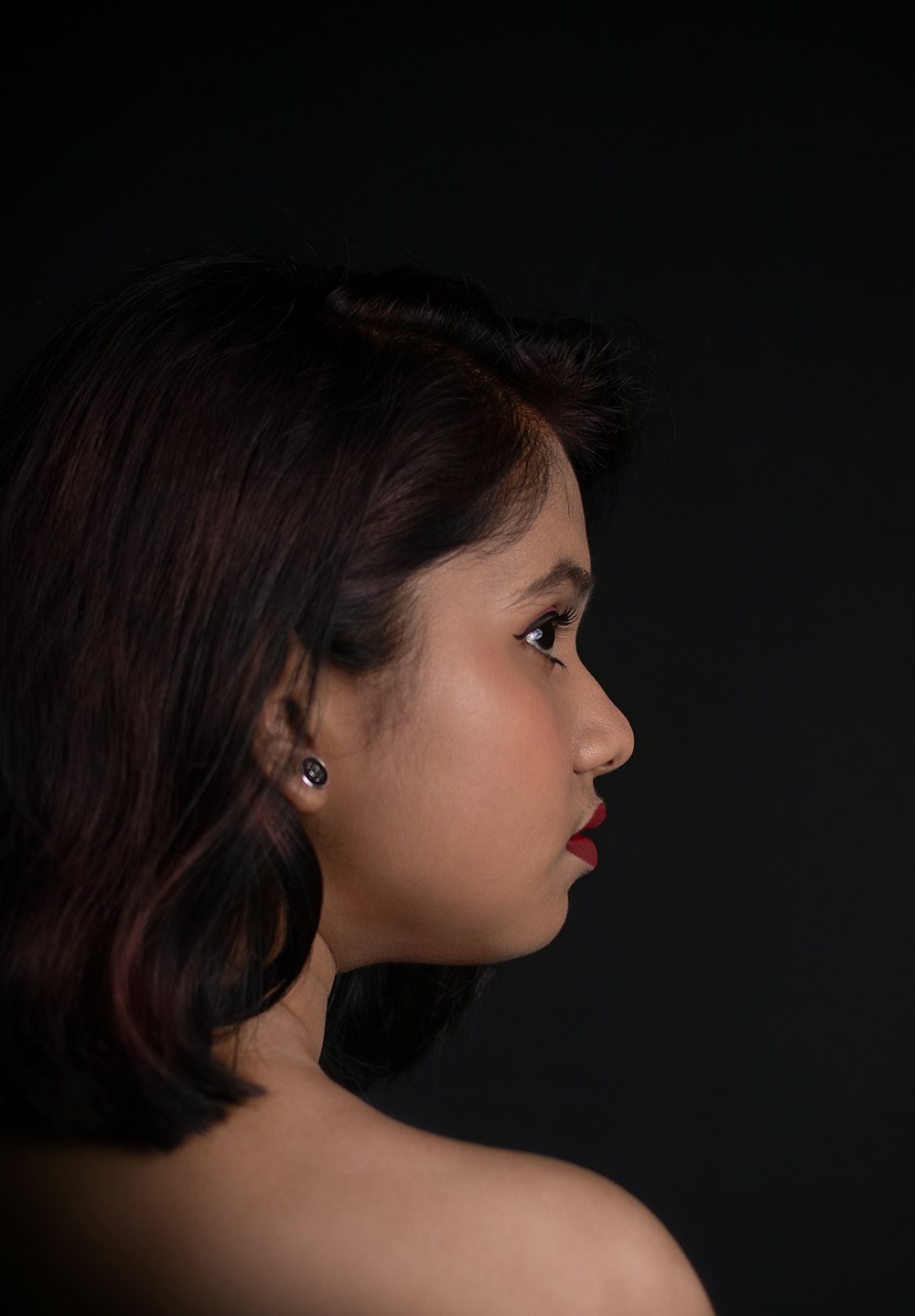 woman in black shirt with silver earrings