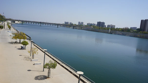 A clean river flowing through a thoughtfully planned urban area with pedestrian bridges.