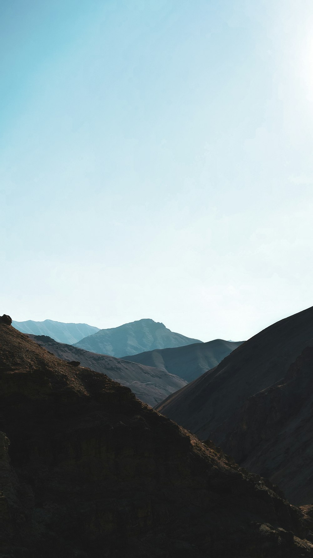 person standing on brown rock mountain during daytime