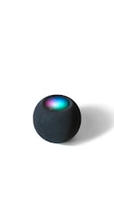 A spherical smart speaker with a mesh-like texture sits on a flat surface. The top of the device exhibits a glowing LED display with vibrant colors including blue, green, and purple.