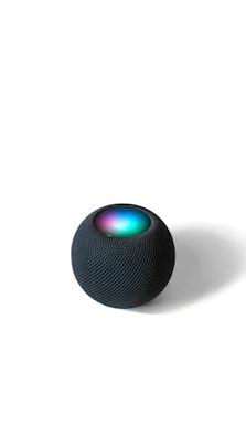 Close-up of a sleek AI-powered smart home device glowing softly in a modern living room