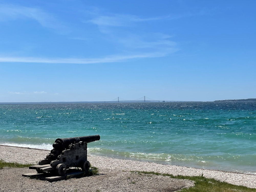 black metal bench on beach shore during daytime