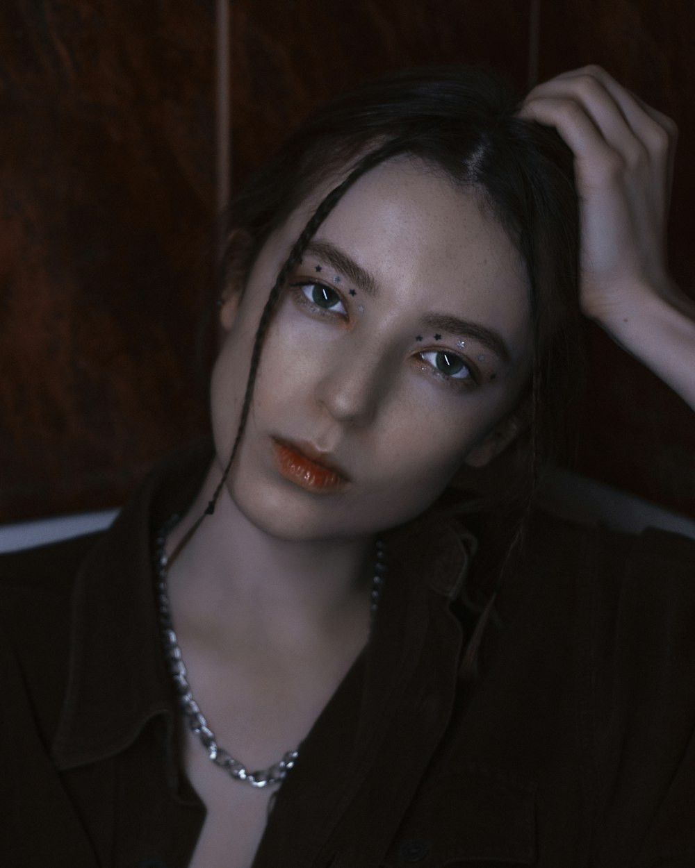 woman in black blazer and silver necklace