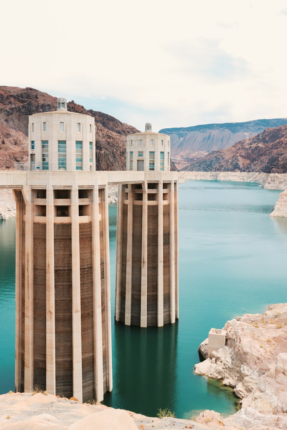 brown and white concrete building near body of water during daytime