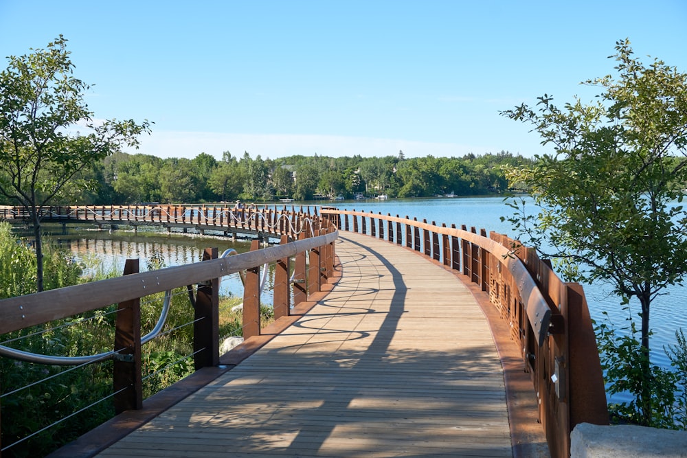 brown wooden bridge over blue sea under blue sky during daytime