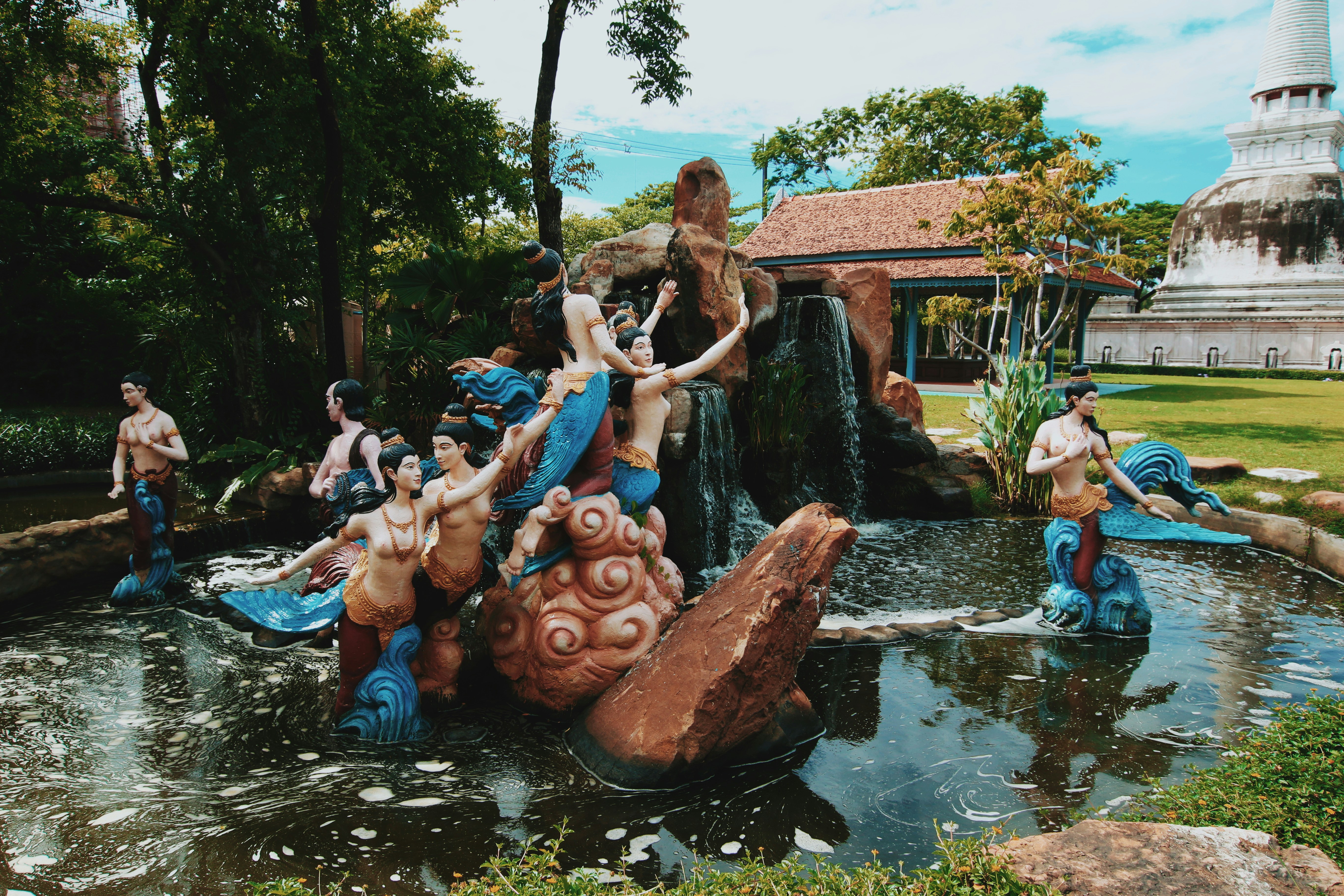 people sitting on brown wooden log in water