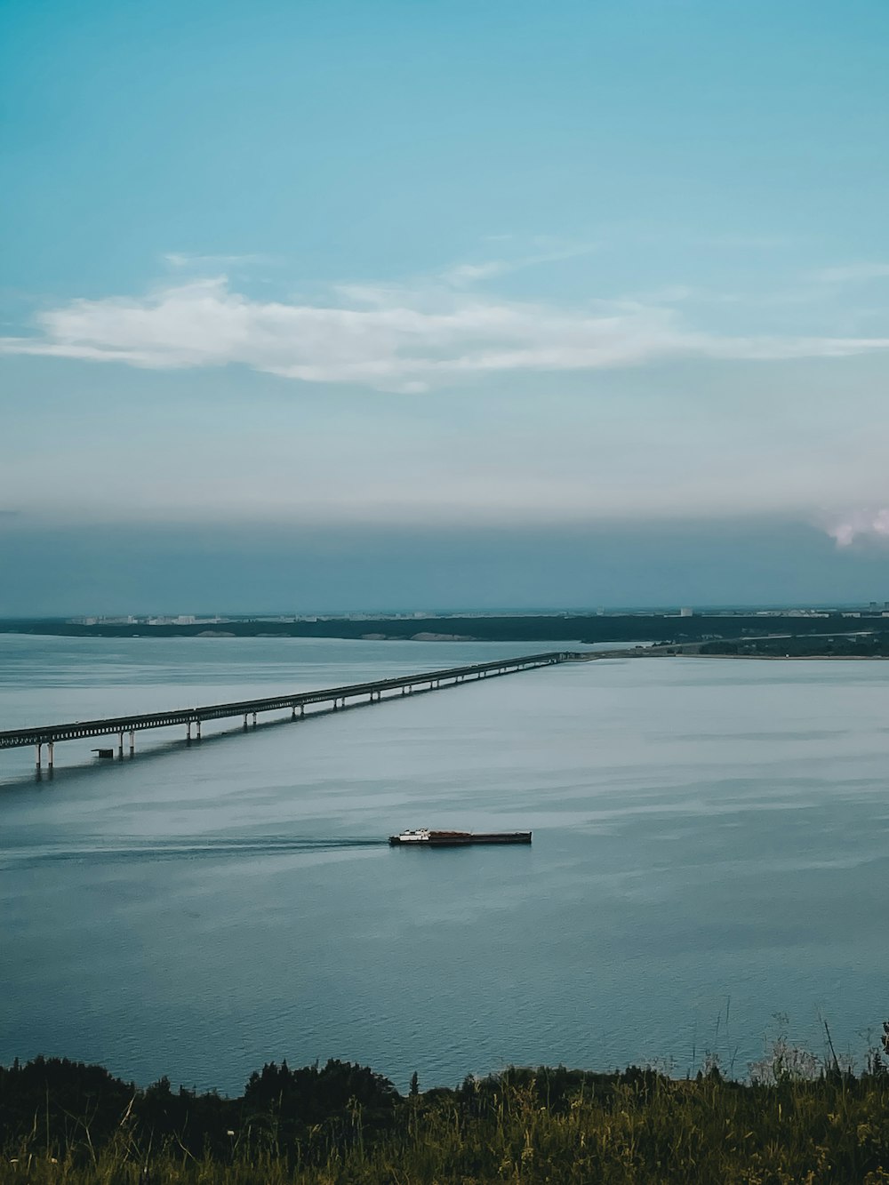 sea dock under white clouds during daytime