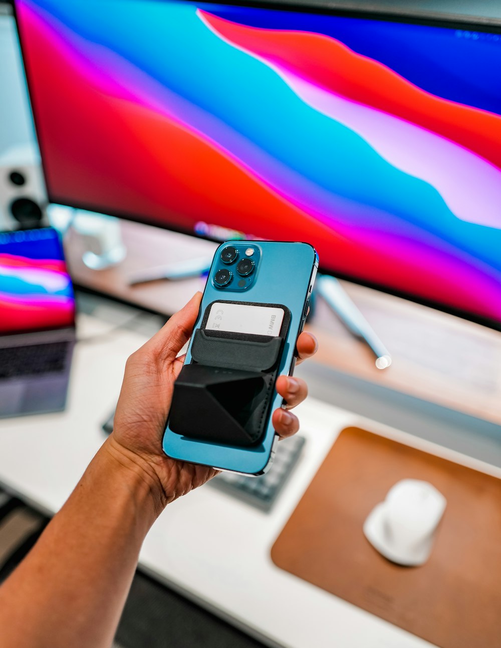 person holding iphone with blue case