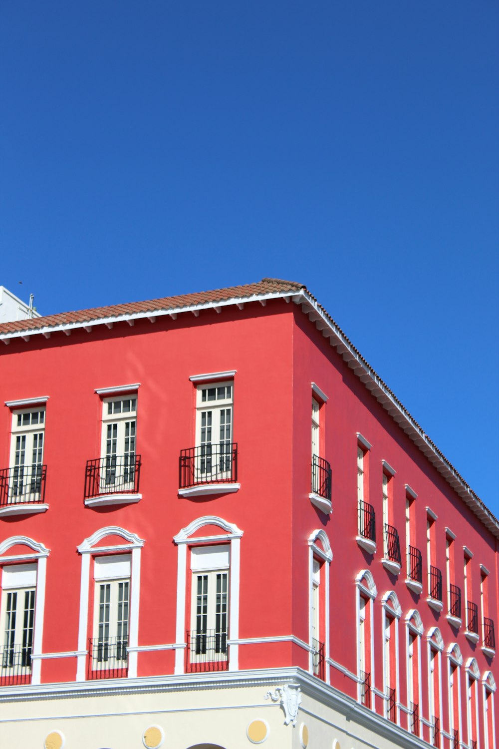 red and white concrete building under blue sky during daytime