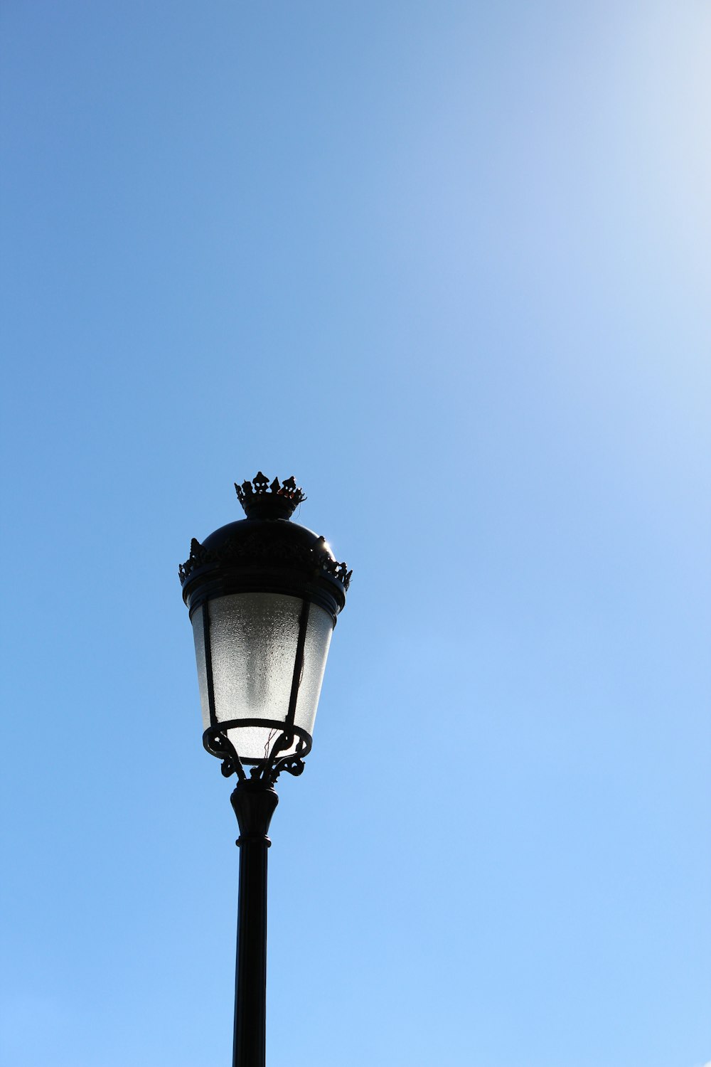 black street light under blue sky during daytime