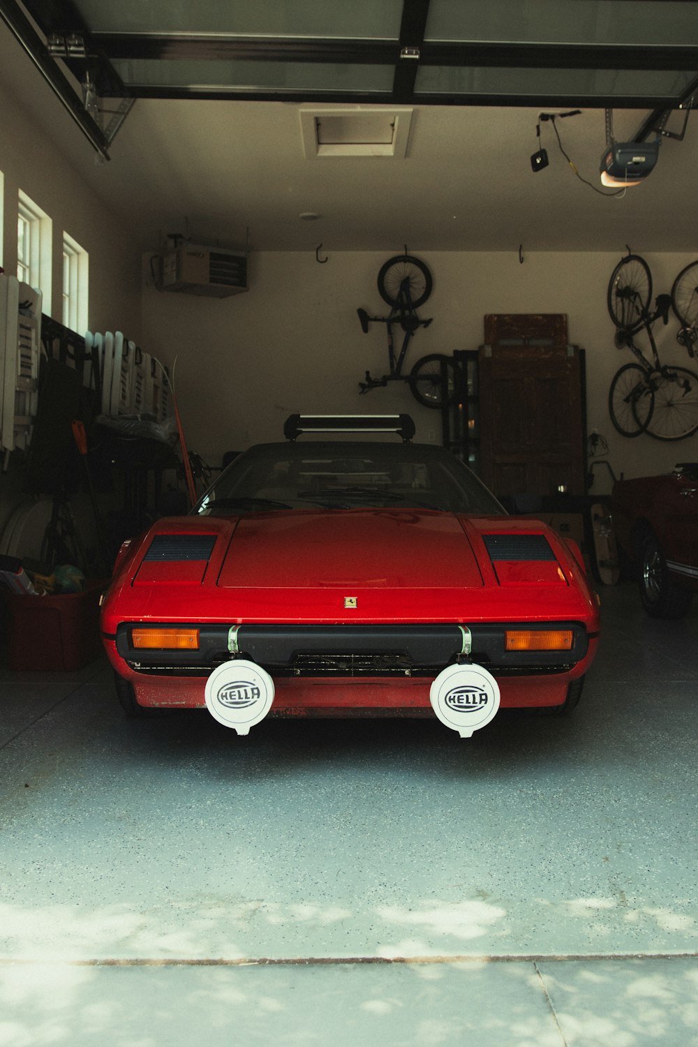 red chevrolet camaro parked in garage