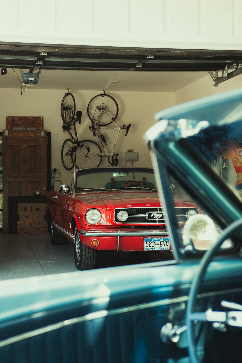 red car in garage during daytime