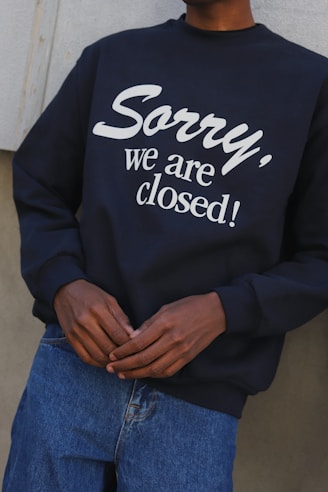 person in black and white long sleeve shirt and blue denim jeans