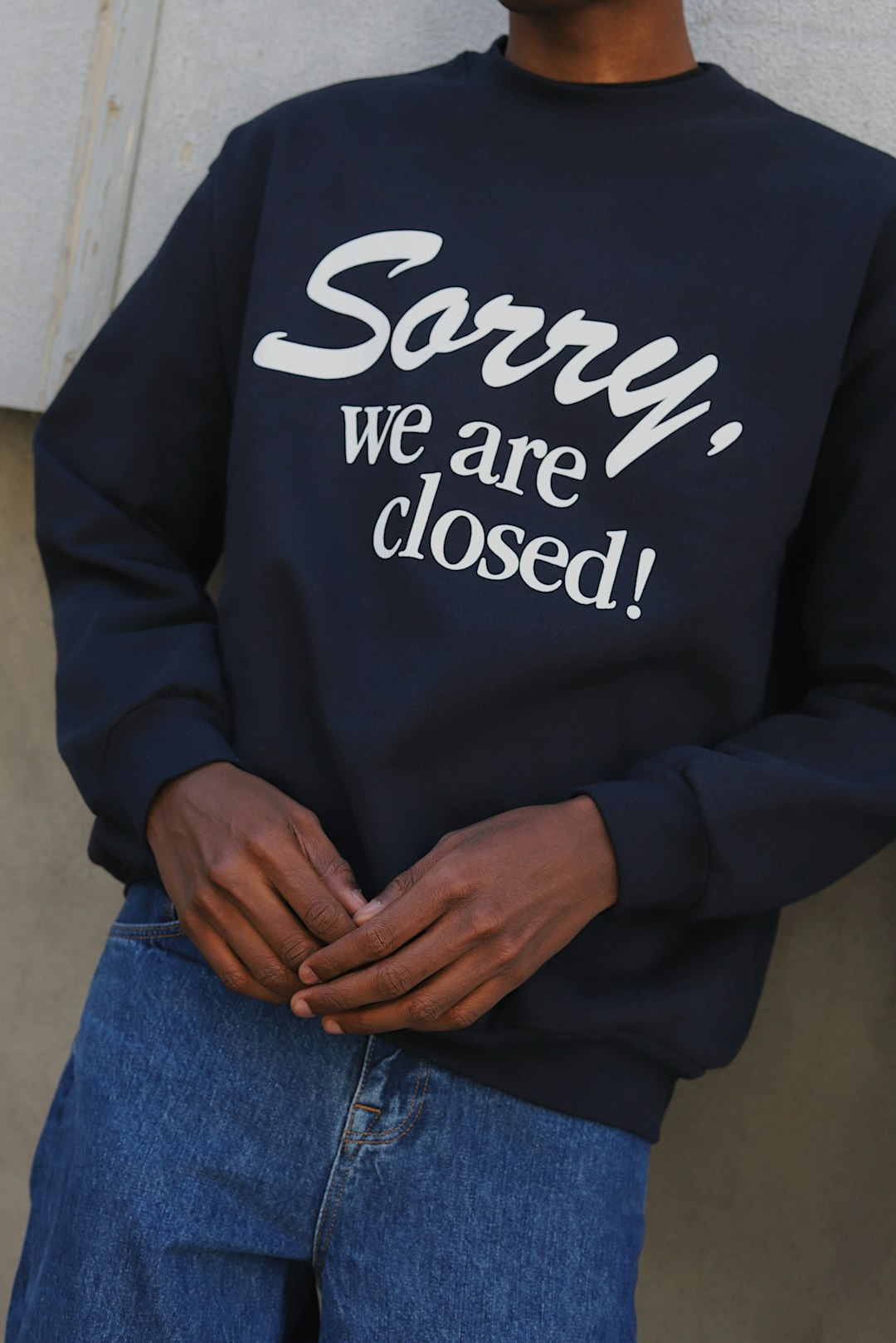 person in black and white long sleeve shirt and blue denim jeans